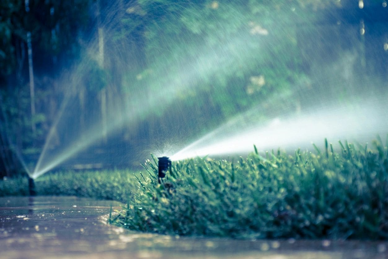 A water sprinkler spraying water on the ground.